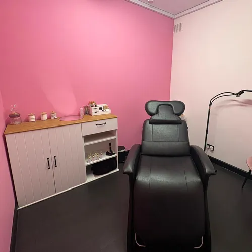 A treatment chair in a pink room at Brilliance Too