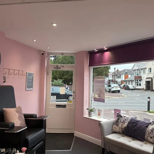Inside Brilliance Beauty Salon, the nail desks and varnish wall