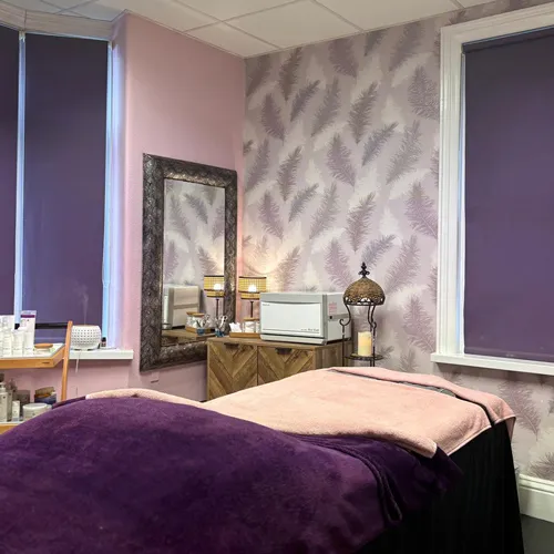 A treatment room with the feather wallpaper