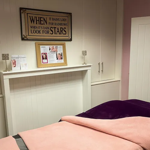 A treatment room with a fireplace and framed sign